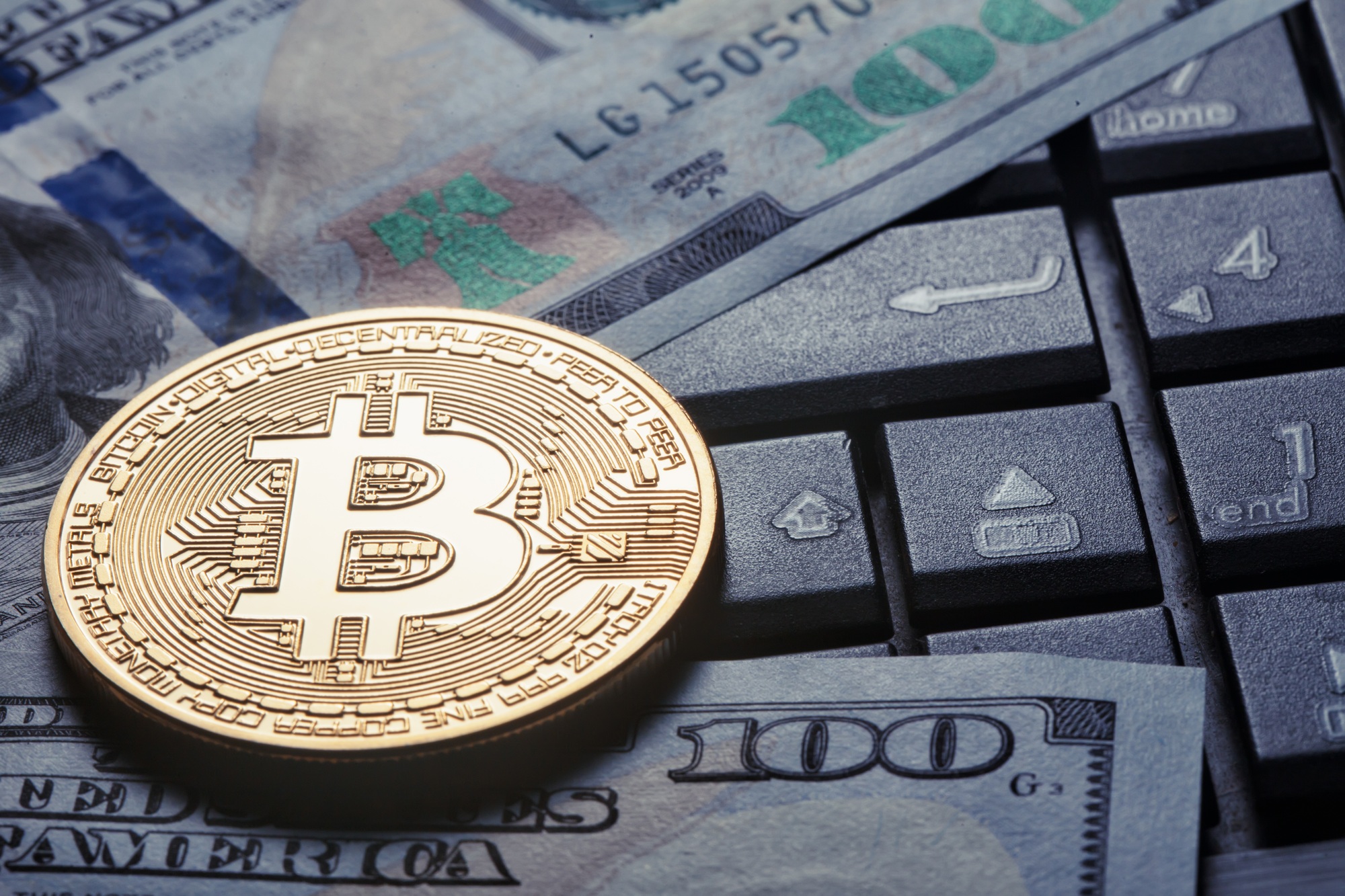 Virtual currency bitcoin against the background of dollars and c